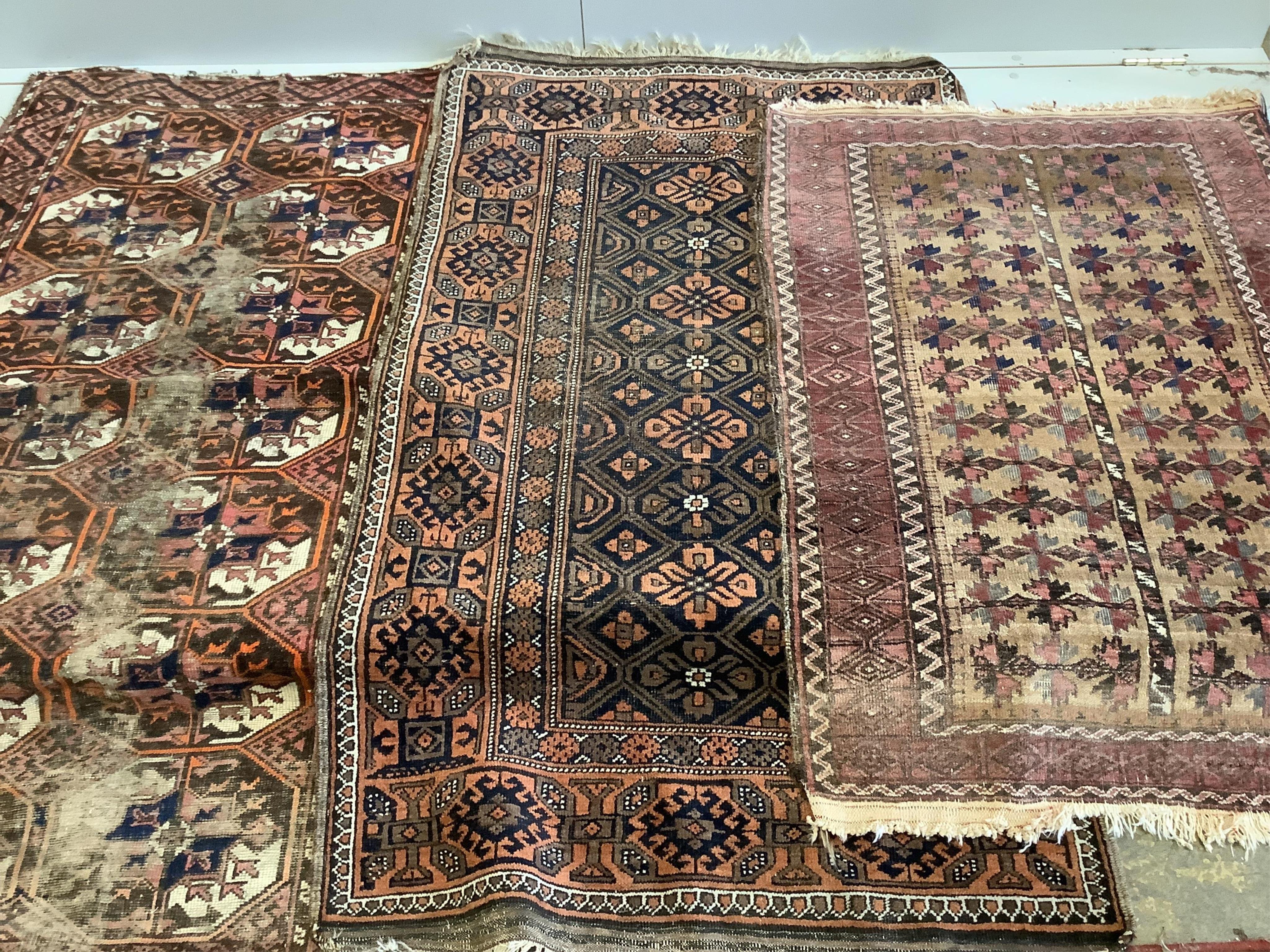 Two Belouch rugs and a Bokhara rug (worn), largest 170 x 90cm. Condition - fair-poor